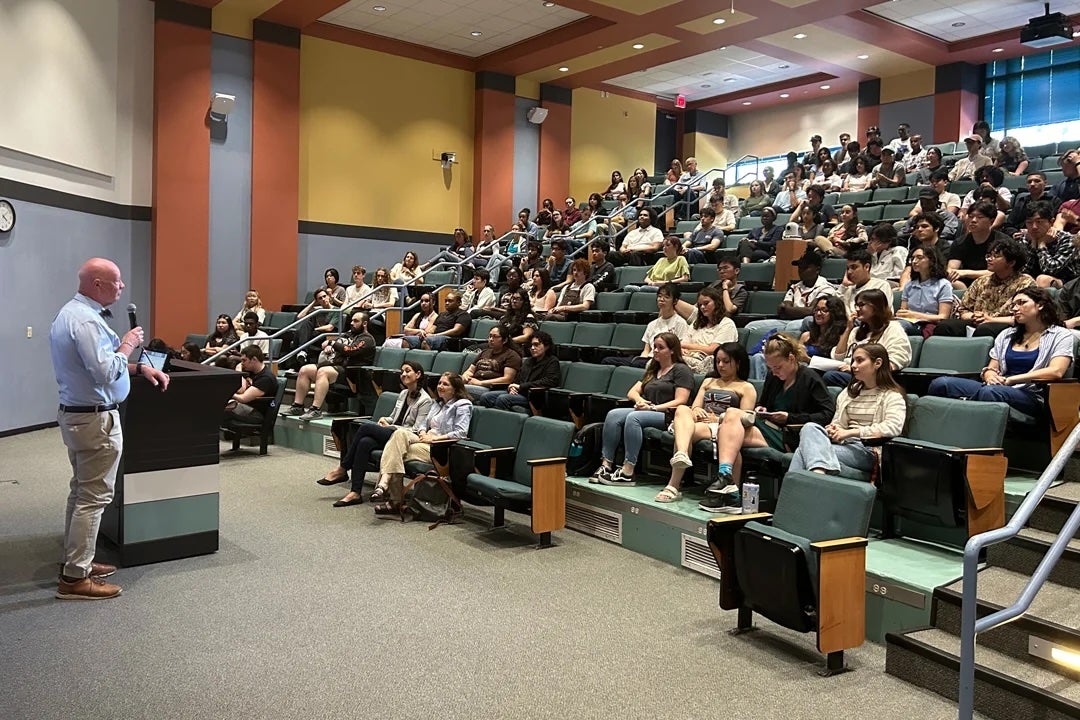 Ken Whitmire, professor of chemistry and Natural Sciences' associate dean for academic affairs, welcomes undergraduate summer researchers to Rice at a May 31 reception in Duncan Hall. (Photo by Jay Bethea/OURI)