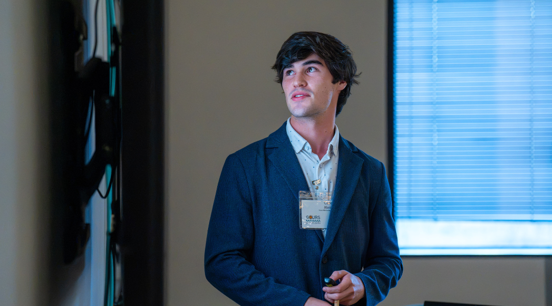 An undergraduate student gives his research presentation