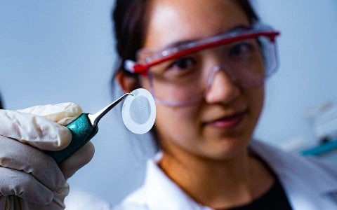 Rice University graduate student Natsumi Komatsu was the first to notice that the alignment of 2D carbon nanotube films corresponds to grooves in the filter paper beneath the films. (Photo by Jeff Fitlow/Rice University)