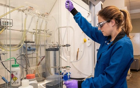 Rice University graduate student Nicole Behnke prepares a laboratory experiment to produce azetidines, chemical compounds that serve as precursors for drug design. The Rice lab discovered a simple method to produce the valuable compounds. (Credit: Jeff Fitlow/Rice University)